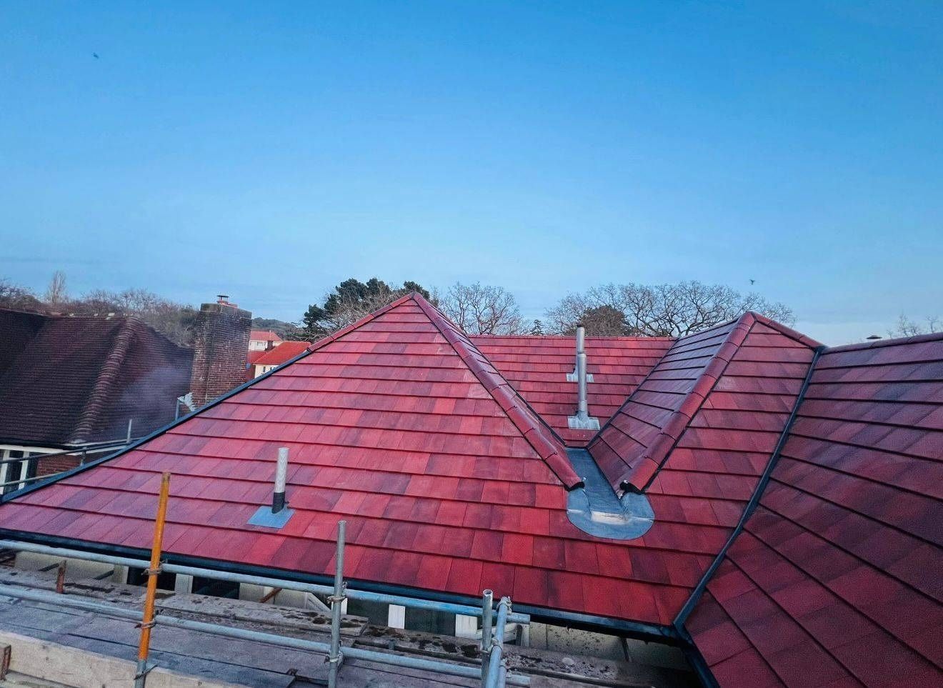 Front elevation of a completed clay tile hipped roof replacement in Canterbury