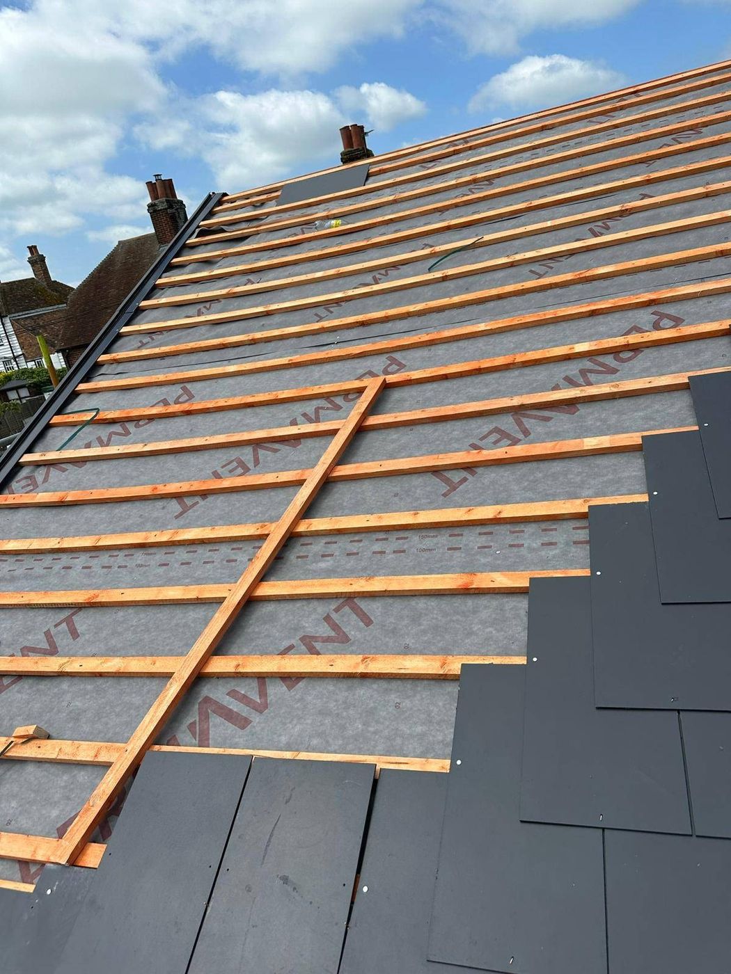 New battens over breathable membrane before natural slate is laid on a Canterbury roof