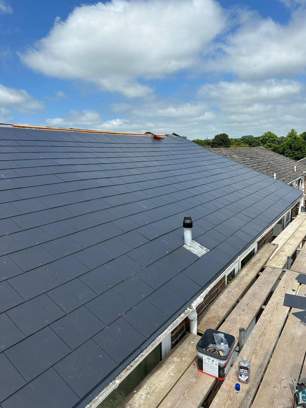 Completed natural slate roof in Canterbury with flashed vent