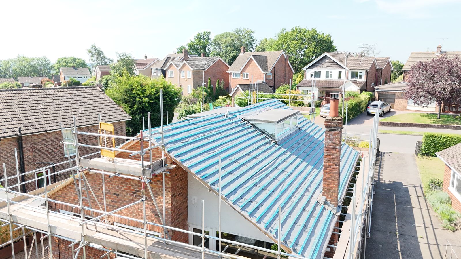 New battens across the full slope of a Canterbury bungalow re-roof, chimney in view
