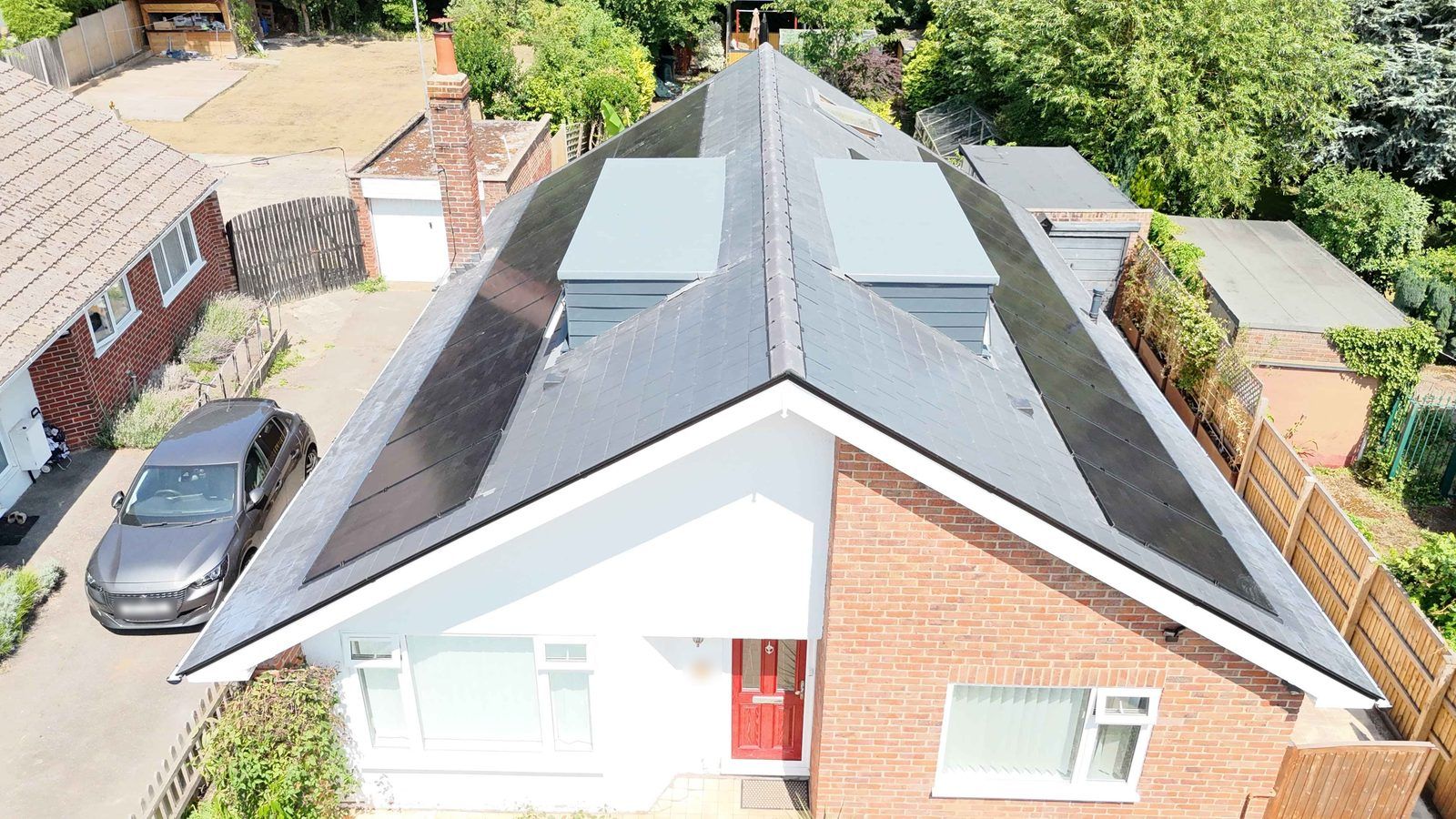 Front of a Canterbury bungalow after a re-roof with in-roof solar panels on both slopes